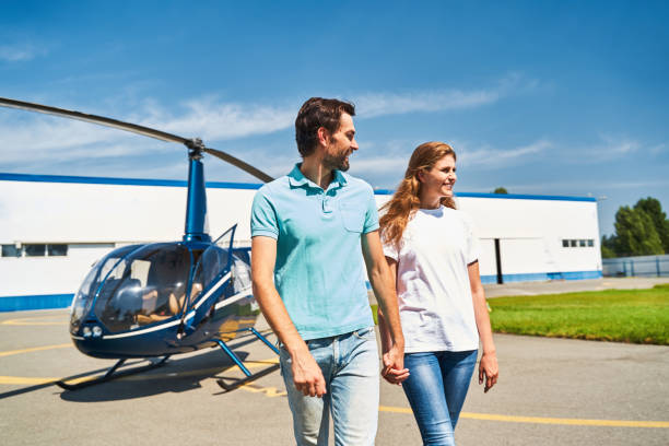 istock Happy romantic couple moving away from private helicopter 1343492087