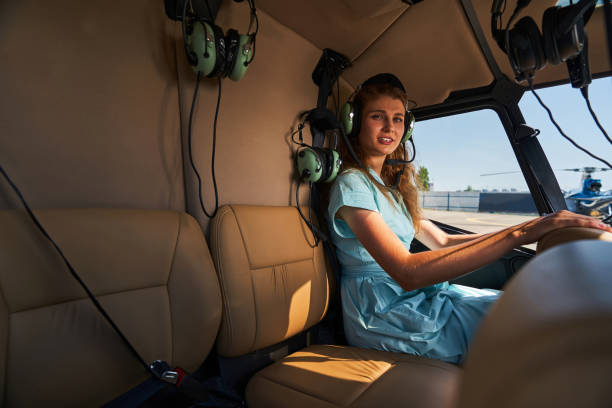 istock Young Caucasian female passenger sitting in helicopter cockpit 1343492143