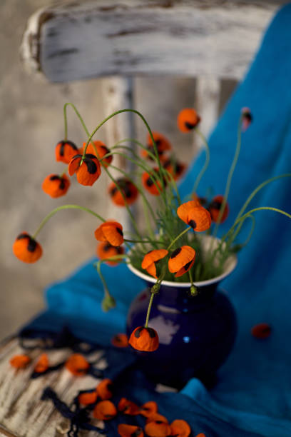 istock A Little Red Poppies Bouquet in blue vase 1343495105