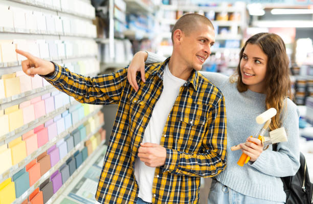 istock Married couple chooses tiles according to color samples in hardware store 1343496025