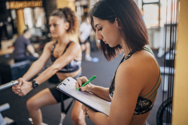 istock Fitness trainer controlling a woman's training 1343497304