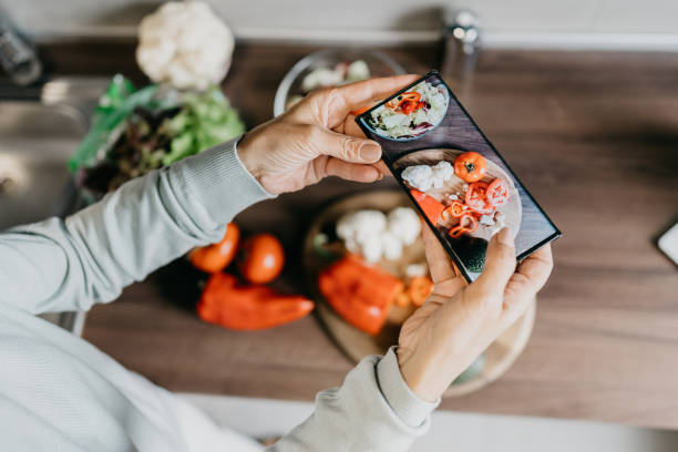 istock Woman using laptop and make a phone call in the kitchen 1343497312