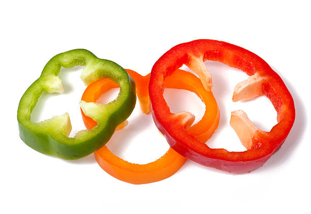 istock Orange green and red pepper slices on white background 134349733