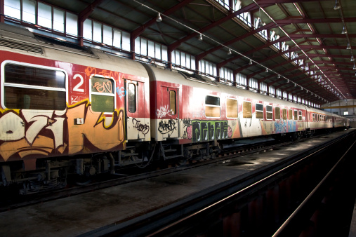 Berlin, Germany – July 08, 2019: A subway station in Berlin, Germany with the wall beside the rails covered in graffiti spray paint