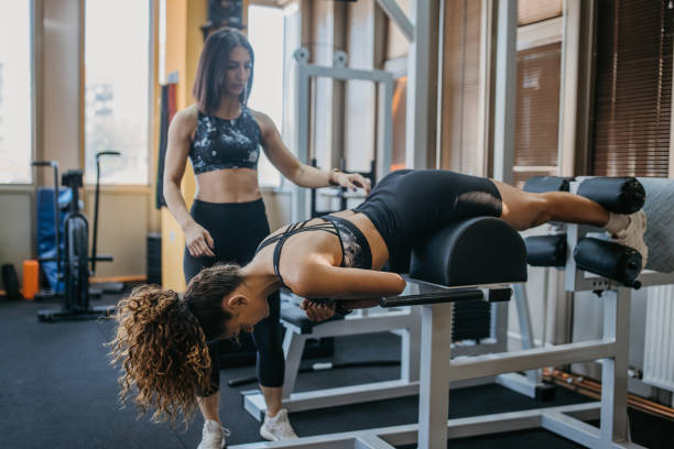 istock Personal trainer assisting a woman in practice 1343499823