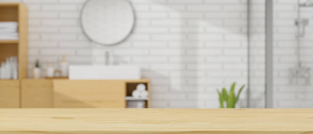 istock Mockup space on wooden tabletop over blurry modern Scandinavian bathroom interior 1343501738