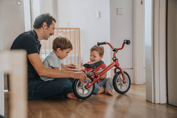 istock Father fixing a bike at home 1343502331