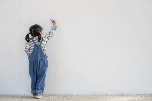 istock Little children painting on white wall 1343502873