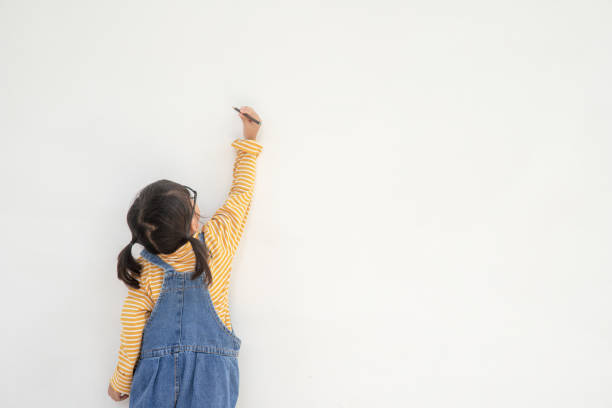istock Little children painting on white wall 1343503132
