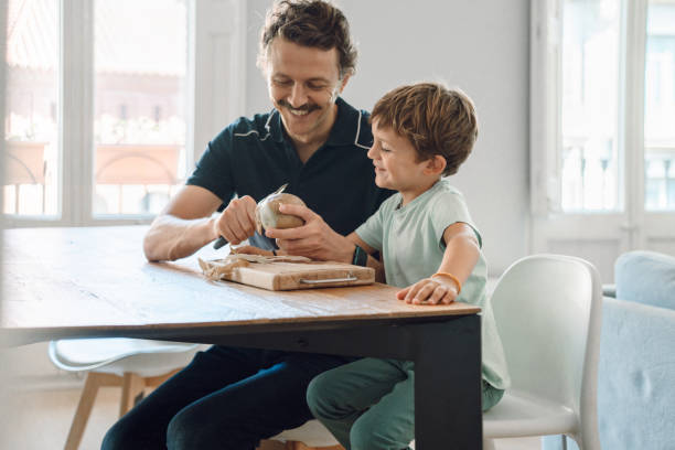 istock Father and son cutting potatoes 1343503437