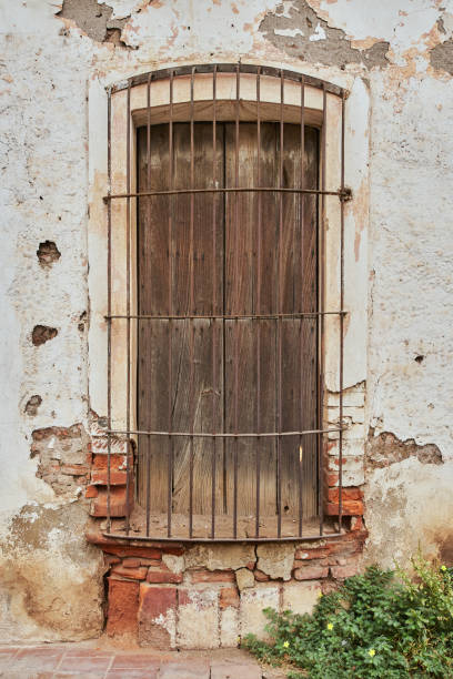 istock Rundown and deteriorated facade with very rustic old rusted metal fenestration 1343505019