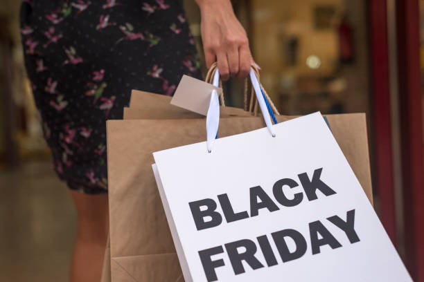 Close-up of a woman's hand carrying paper bags on black friday stock photo