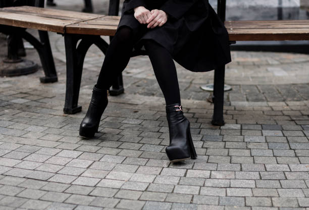istock woman in black coat and leather boots 1343507199