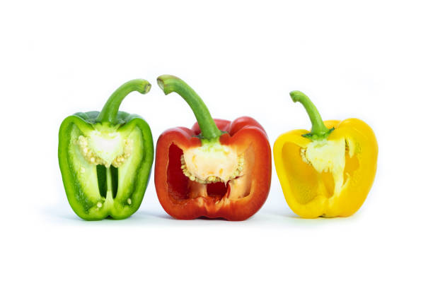 istock Three bell peppers, cut in half. Bell pepers is red, green and yellow on white background. Colorful vegetables. 1343507253