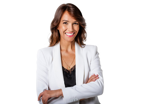 Studio portrait shot of attractive middle aged woman with toothy smile wearing blazer while standing at isolated white background. Copy space.
