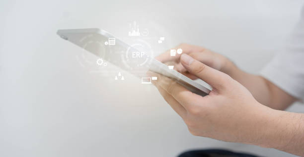 istock close up employee man hand hold digital let and using ERP program application to connect with team or check system for future business and data development concept 1343510170
