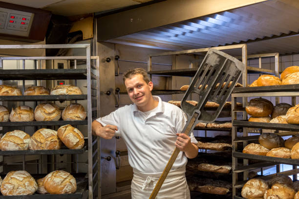 istock One Baker in his bakery, baking bread. Portrait. 1343511300