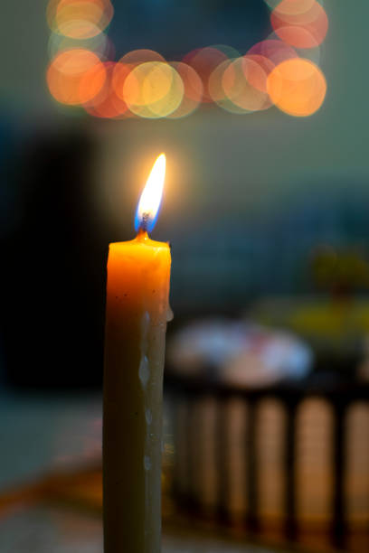 istock Candle lightened and bokeh light with birthday cake in blurred background. Used selective focus. 1343513452