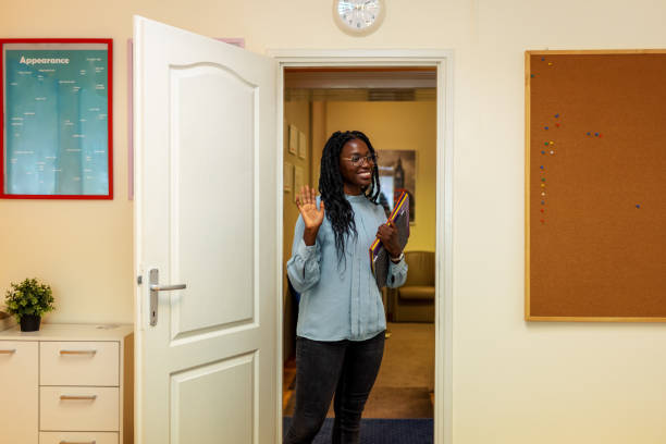 istock Black Female Teacher Greeting Students In The Classroom 1343514195