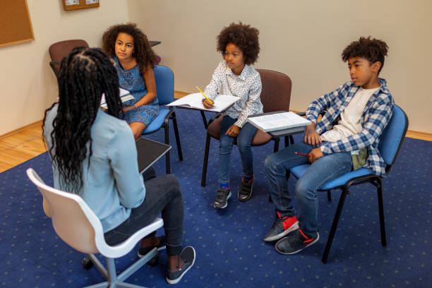 istock Female Teacher Talks With Small Group Of Students 1343515585