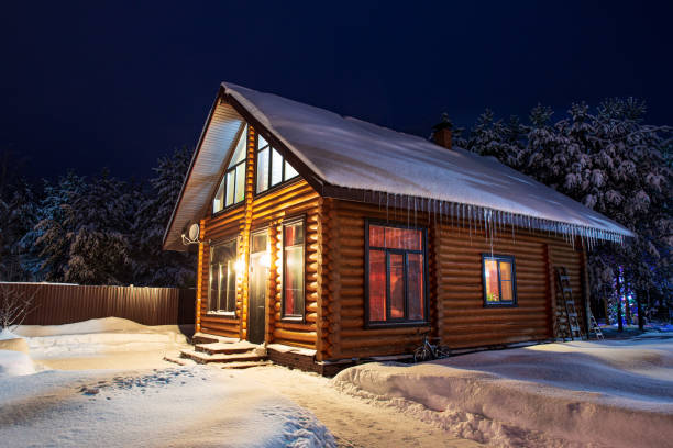istock Rustic log house, snow-covered pine trees, snowdrifts, fabulous winter night. 1343517003