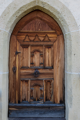 Nice brown wooden door with fittings. It is the entrance door to the church