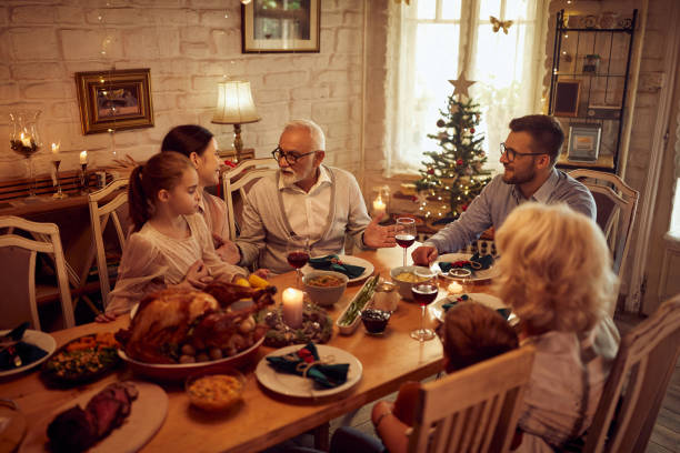 istock Happy extended family talking during Thanksgiving meal at dining table. 1343520127