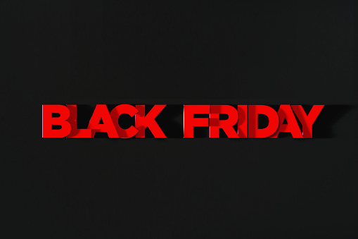 Red letters writing Black Friday on black background. Horizontal composition with copy space. Directly above. Great use for Black Friday concepts.