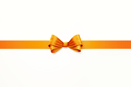 Orange ribbon sitting over white background. Horizontal composition with  copy space. Thanksgiving concept.