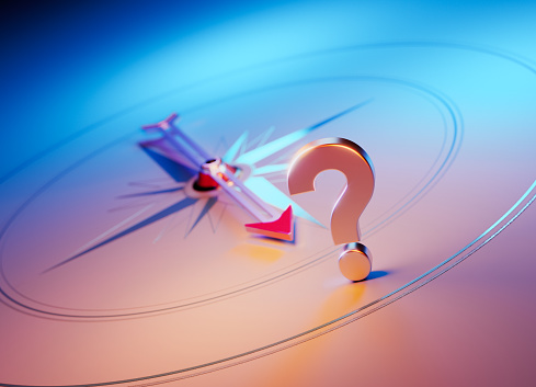 Arrow of the compass is pointing the question mark symbol. Horizontal composition with copy space. Q and A concept.