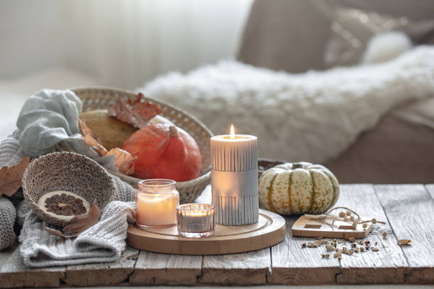 istock Cozy autumn composition with candles and pumpkins in a home interior. 1343523672