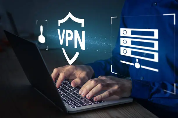 Photo of VPN secure connection concept. Person using Virtual Private Network technology on laptop computer to create encrypted tunnel to remote server on internet to protect data privacy or bypass censorship