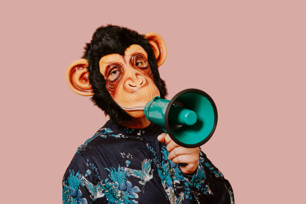 istock man wearing a monkey mask speaks into a megaphone 1343525297