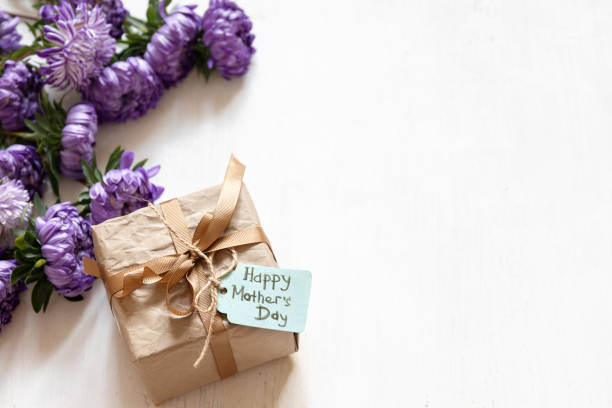 istock Gift box with a wish for a happy mother's day on a white background, copy space. 1343527024