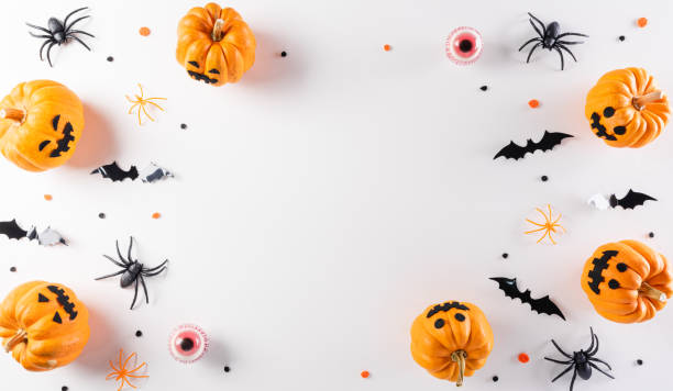 istock Halloween decorations made from pumpkin, paper bats and black spider on white background. Flat lay, top view with copy space for text. 1343527675
