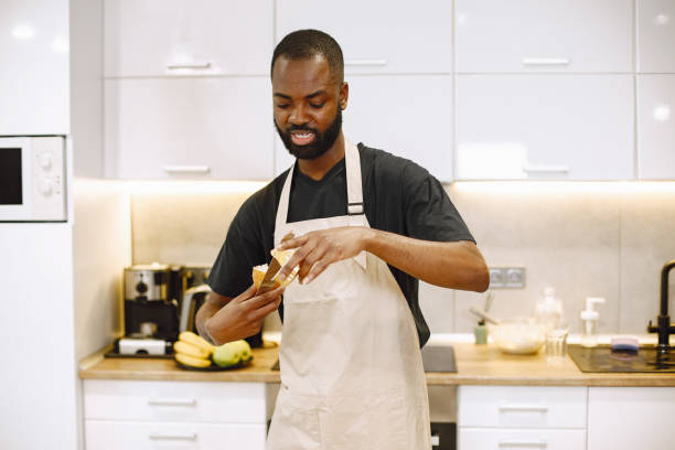 istock African-american man in a kitchen holding a bread 1343529172