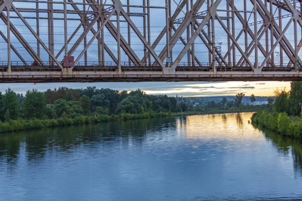 istock Iron transport bridge over the river during sunset 1343529761