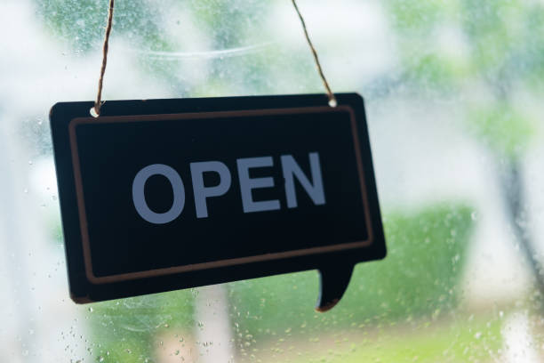istock Cafe or restaurant reopens and shows sign wood board label with message OPEN after Coronavirus quarantine is over. 1343531675