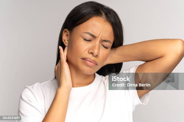 Tired African Girl Suffer From Neck Pain Spinal Problem Incorrect Posture Fibromyalgia Neck Ache Stock Photo - Download Image Now