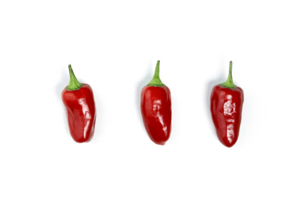istock Red mini chili pepper isolated on white background with shadow, top view. Hot seasoning. Medicinal products. 1343535310