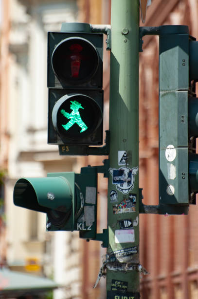 Ampelmann street crossing icon is a symbol of Berlin The  Ampelmännchen GEHER (walking man) street crossing icon is a symbol of Berlin and an important component of the tourism business and the East Germany nostalgia movement. ampelmännchen photos stock pictures, royalty-free photos & images