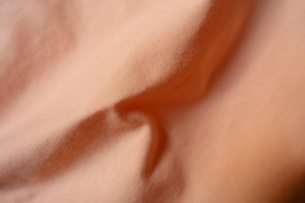 istock apricot colored simple cotton jersey fabric with soft folds 1343539558
