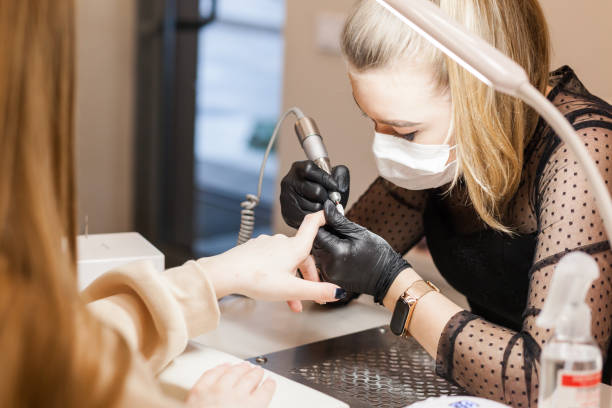 istock The manicurist processes the client's nails. 1343540267