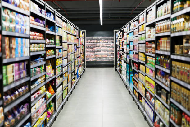 shot of a empty aisle in a supermarket - supermarket imagens e fotografias de stock