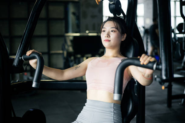 istock Young women doing chest exercises in a gym 1343543927