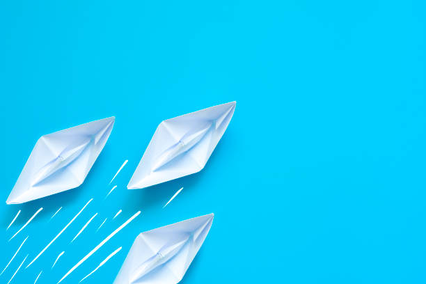 istock Paper boat on blue background 1343544050