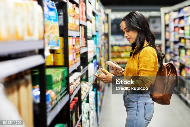 Shot Of A Young Woman Shopping For Groceries In A Supermarket Stock Photo - Download Image Now