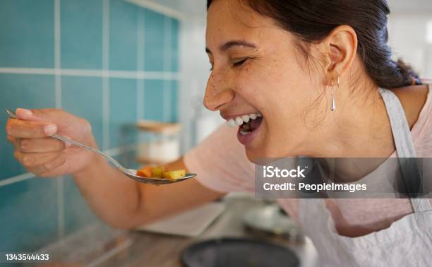 Shot Of A Young Woman Tasting Her Food Stock Photo - Download Image Now - Healthy Eating, Spoon, Women