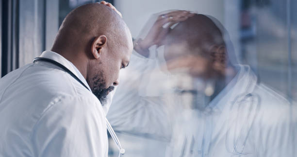 shot of a male doctor having a stressful day at work - male african descent africa ethnic imagens e fotografias de stock