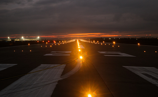 lights on the landing strip at the airport in the evening